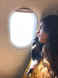 Woman sleeping while traveling in airplane