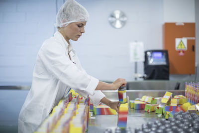 Woman packing flasks in medical factory