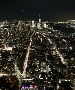 Aerial view of city lit up at night