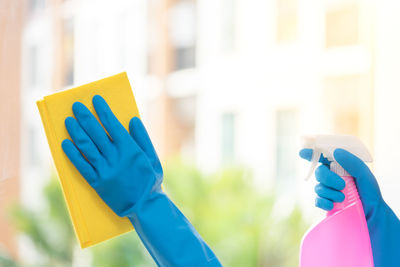 Close-up of woman cleaning glass