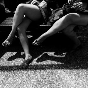 Low section of man sitting outdoors