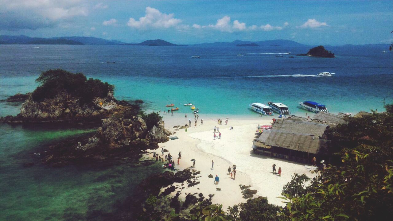 HIGH ANGLE VIEW OF PEOPLE ON SEA SHORE