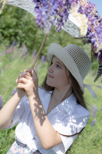 Midsection of woman holding flowers