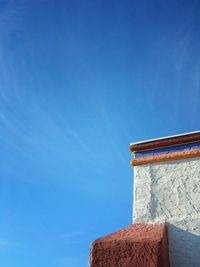 High section of built structure against clear blue sky