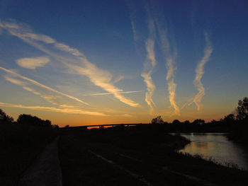 Panoramic view of silhouette road against sky during sunset