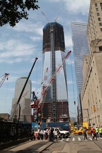 Construction site by buildings against sky in city