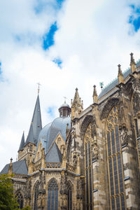 Low angle view of cathedral against cloudy sky