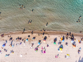 Directly above shot of people at beach on sunny day