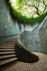 Brick wall by trees