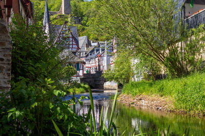 The village monreal with river elz, half-timbered houses and castle loewenburg in the background