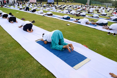 New delhi, india, june 21, 2023 - group yoga exercise session for people at yamuna sports complex