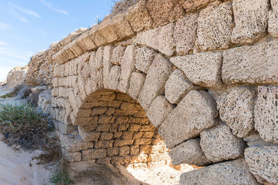 Low angle view of stone wall