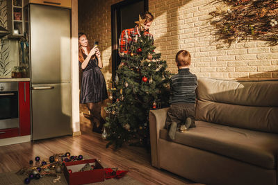 Woman sitting on sofa at home