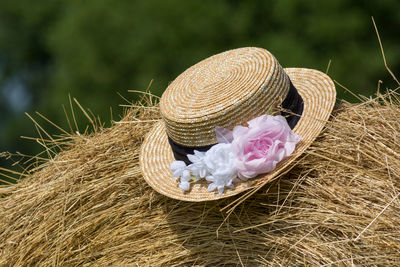 Close-up of hat on hay bales