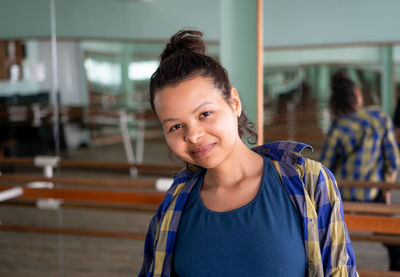 Portrait of young beautiful black woman in choreography hall with mirrored walls