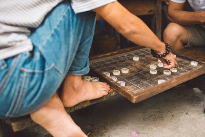 Men playing board game outdoors