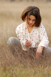 Woman sitting on field