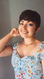 Portrait of a smiling young woman using smart phone