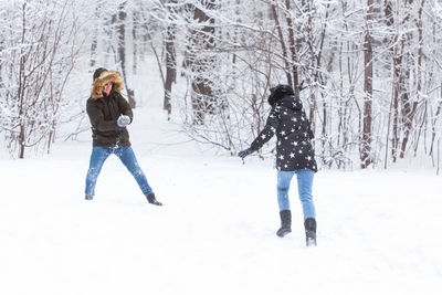 Full length of woman standing on snow covered land