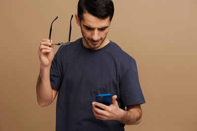 Portrait of young man using mobile phone