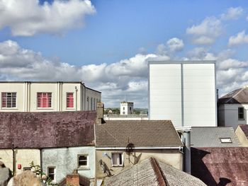 Houses against cloudy sky