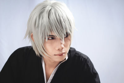 Portrait of woman against white background