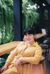 Portrait of smiling woman sitting on seat