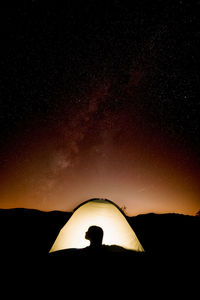 Silhouette man against sky at night