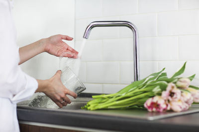 Midsection of woman preparing food in kitchen at home