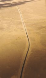 Aerial view of road passing through land