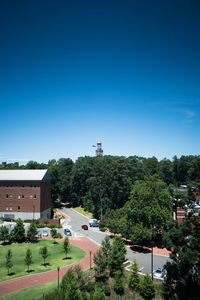 Mid distance view of morehead-patterson bell tower by trees against sky