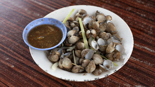 Fresh boiled mussels in a plate cooked by malaysian street hawker. asian food