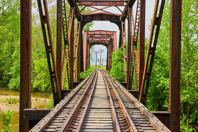 Rear view of man walking on footbridge