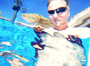 Portrait of man swimming in pool