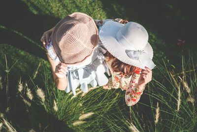 Rear view of woman wearing hat on field