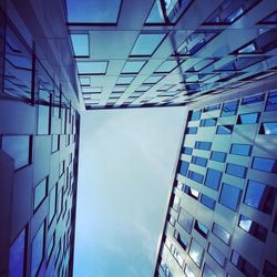 Low angle view of modern building against blue sky