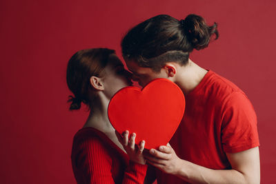 Side view of woman holding heart shape