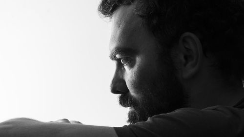 Close-up portrait of young man looking away