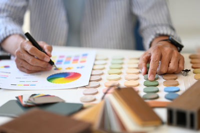 Midsection of business colleagues working on table