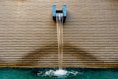 Water pipe on closed metal against blue wall