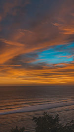 Scenic view of sea against orange sky