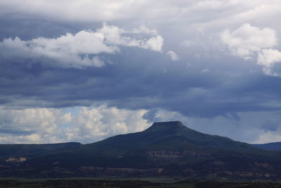 Countryside landscape against mountain range