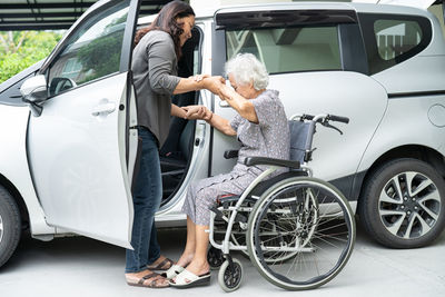 Low angle view of man holding car