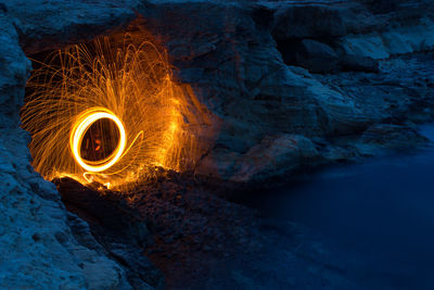 Illuminated wire wool at rock formation