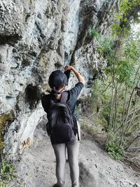 Rear view of woman standing by mountain