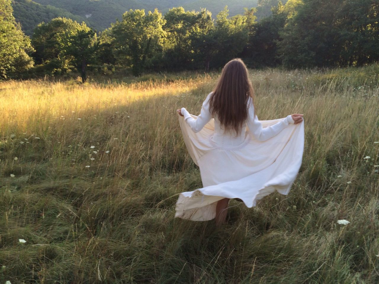 grass, field, grassy, one animal, relaxation, pets, sitting, domestic animals, nature, plant, animal themes, one person, day, growth, tranquility, resting, full length, sunlight, outdoors, lying down