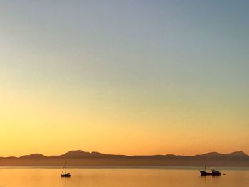 Scenic view of sea against clear sky during sunset