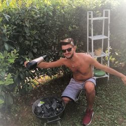 Young man wearing sunglasses and plants