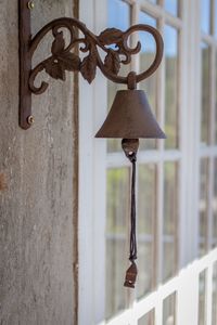 Close-up of lamp hanging against wall