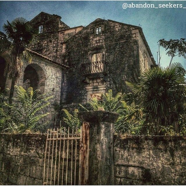 architecture, built structure, building exterior, old, low angle view, house, tree, sky, plant, arch, history, weathered, outdoors, wall - building feature, day, stone wall, building, growth, no people, residential structure